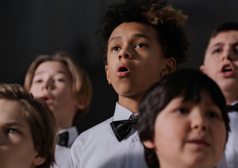 Children singing together in a choir rehearsal